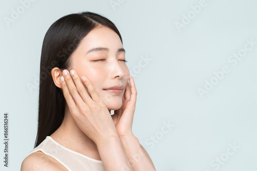 Skin care. Woman with beauty face touching healthy facial skin portrait. Asian woman. 