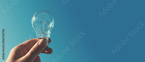 Man with bulb on sky background, idea concept