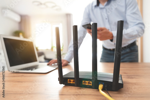 Modern wi-fi router on light table in room