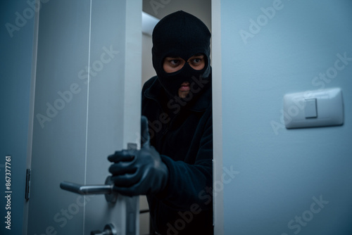 Thief in uniform black jacket various action housebreak. The Robber terrorism criminal escapes with balaclava and crowbar entering a house for stealing Housebreak at night