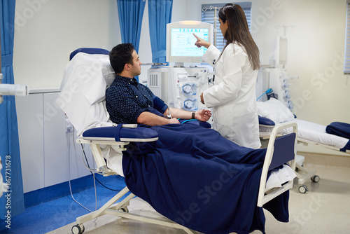 Man, doctor and dialysis machine in hospital for kidney assessment, organ fail and medical diagnosis for health. Patient, woman and screen exam for Nephrology, filter blood and hemodialysis treatment