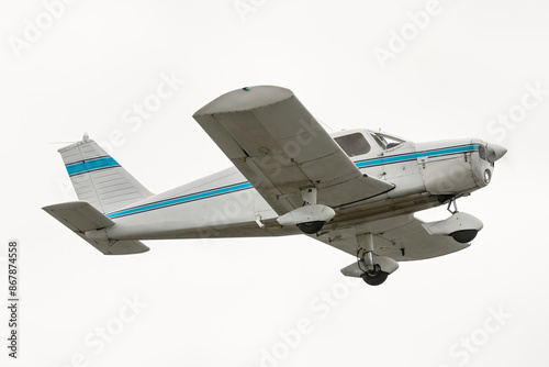 Light aircraft takeoff, isolated on white background. Small single engine general aviation plane. Low wings and propeller and fixed landing gear. Painted white with blue stripe