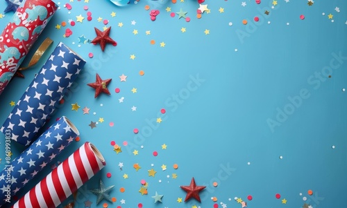 Festive wrapping paper with stars and stripes on blue background with scattered confetti