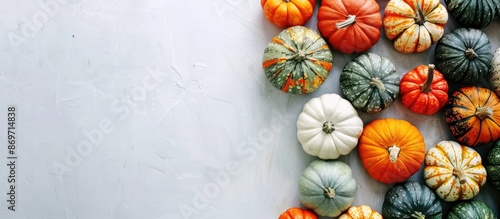 Top view of pumpkins on a white background with space for text - a creative autumn-themed image perfect for Thanksgiving.