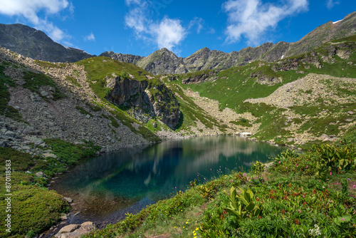 View of the Dukka lake "Rybka" on the Malaya Dukka River on the slopes of the Arkasar ridge in the North Caucasus on a sunny summer day, Arkhyz, Karachay-Cherkessia, Russia