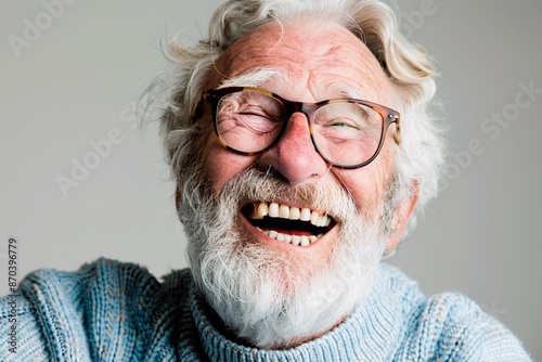 a man with white beard and glasses laughing