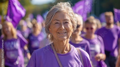 A charity walk with participants of all ages wearing purple T-shirts and holding banners raising funds for Alzheimer's research.