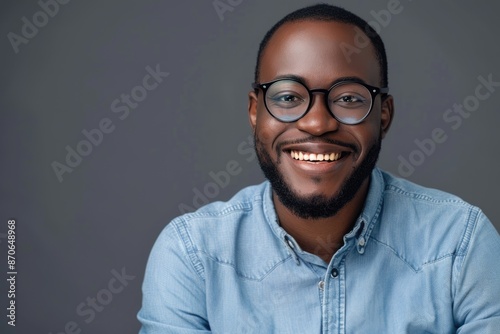 Handsome African man with white smile and glasses pose for portrait.
