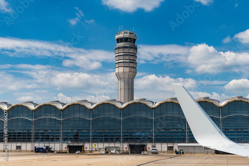 Washington DC, USA - June 04, 2024: Control tower in airport terminal and runway strip. Departure and arrival at airport. American aviation airline. Departure in airport. Control tower airport