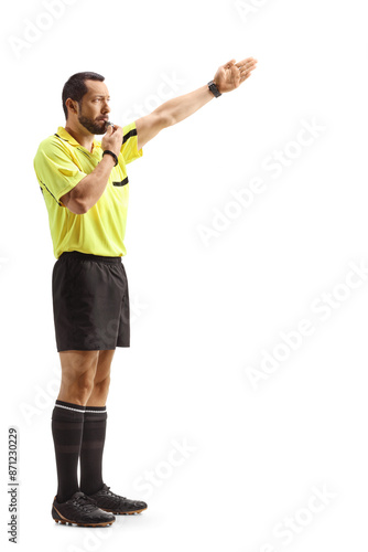 Football referee blowing a whistle and showing offside