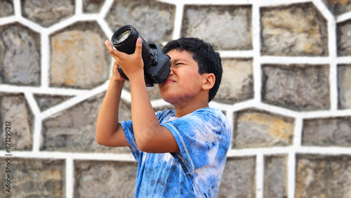 10-year-old dark-skinned Latino boy learns to use a professional camera, dreams and imagines working as an adult