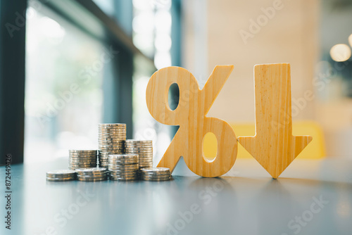 Percentage model, coin stack and down arrow, concepts for success, methods, systems of raising or lowering Fed interest rates to correct inflation concepts.