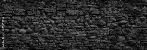 black stone wall, gloomy stonework texture as background