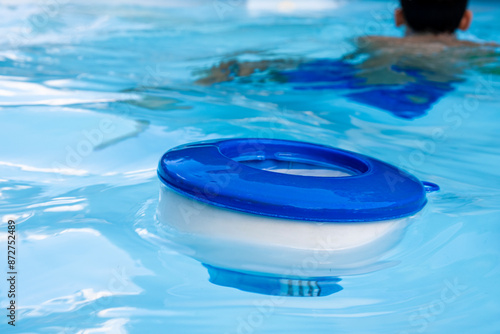 chlorine dispenser floating in a swimming pool