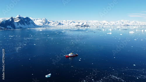 Large vessel in the Southern Ocean, Antarctica. Little boat in the big Ocean. Track from the boat in the frozen ocean