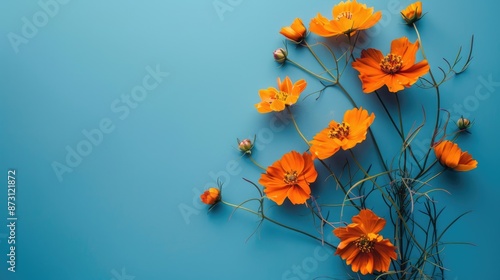 Seasonal concept Vintage orange flowers on blue background with space for text