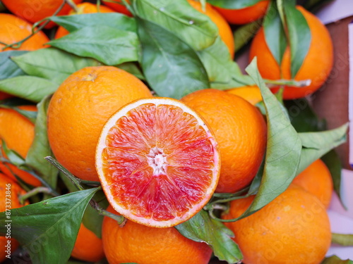 A bunch of oranges with one cut open. stockphoto.