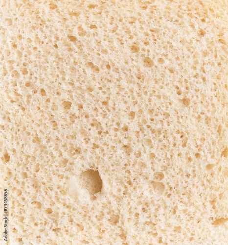 Close-up texture of fresh white bread with visible porous crumb structure, embodying the concept of bakery and nutrition.