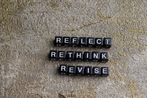 Concept of Reflect, Rethink, revise written on wooden blocks. Cross processed image on Wooden Background