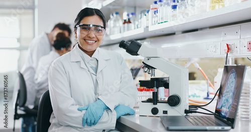 Portrait, science and happy woman on laptop in lab to research chemistry, test or innovation. Microscope, scientist and face of medical doctor in goggles for microbiology, healthcare or pharma study