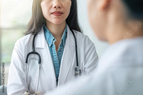 An endocrinologist discusses hormone replacement therapy options with a patient diagnosed with thyroid disorders with copy space