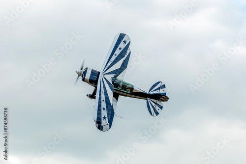 The practice of model airplanes in aerobatics for display at events held by flying clubs around the world with a beautiful biplane airplane