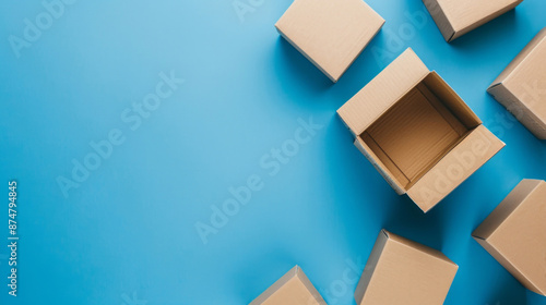 An open cardboard box is surrounded by empty boxes on a blue background, with space for text on the left.