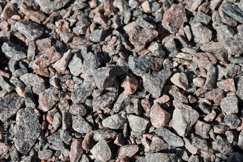 A close-up of small crushed stones spread across the ground. Texture.