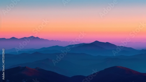 Stunning sunset view over layered mountain ranges in vibrant hues.