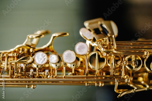 Close-up of a golden saxophone with intricate details and mother-of-pearl keys