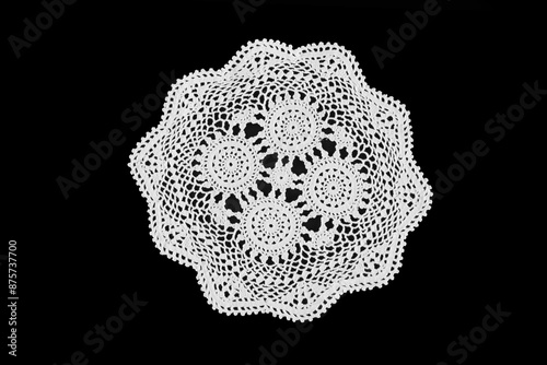 Abstract Grandmas Doily, close up on a black background in black and white