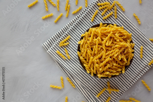 Homemade Raw Dry Gemelli Pasta in a Bowl, top view.