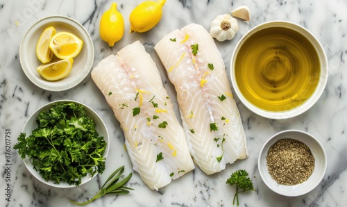 Fish ingredients on a granite countertop, cod fillets, parsley, lemon zest, garlic, olive oil