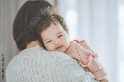 Asian mom mother holding happy baby do a burp after breastfeeding at home, Motherhood, care