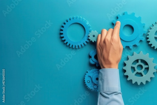 Human hand turning connected cogs, cog connection, manual control over systems