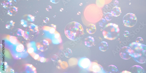 Soap bubbles with rainbow reflections on gray background. Abstract background. Cleaning concept, banner for eco-friendly article or for cleaning service.