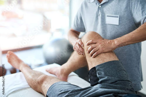 Healthcare, knee and physiotherapist with man patient in clinic for healing, rehabilitation or treatment. Physical therapy, stretch and medical worker with athlete for leg injury or accident recovery