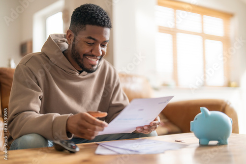 Happy Man Reviewing Bills and Finances At Home