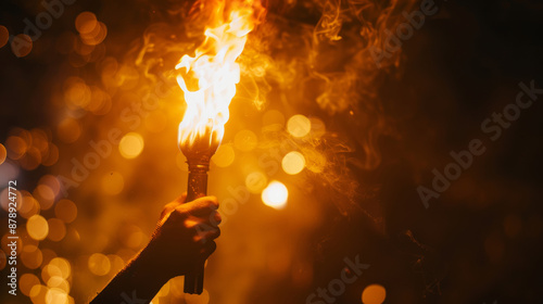 Person holding torch in darkness