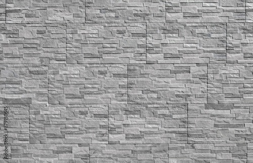 Gray stoneware paneling wall with stone effect. External wall covering. Background and texture.