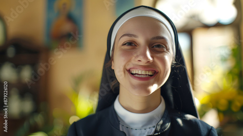 A nun is smiling and looking at the camera