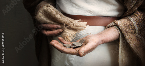 A handful of silver coins in the hands of an old man