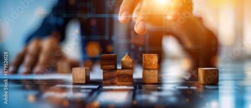 Business strategy concept with hand arranging wooden blocks on a digital interface, symbolizing planning and management in a corporate environment.