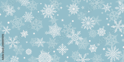 Christmas background of beautiful complex snowflakes, white on light blue. Winter illustration with falling snow.