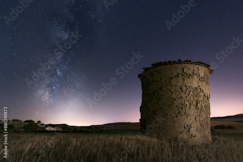 milky way over a cereal field and an old ruined dovecote in El Cerrato, Palencia