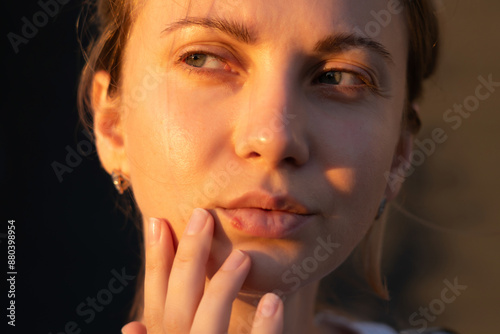 Close up of girl's lips with herpes touching with finger. Beauty dermatology concept