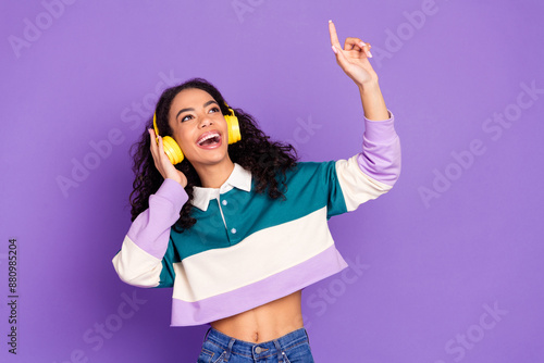 Photo of nice young girl listen music point finger wear shirt isolated on violet color background