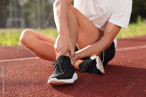 Sportsman with leg injury at stadium, closeup