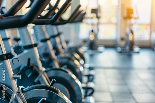 Row of exercise bikes in a gym. Fitness and workout equipment concept.