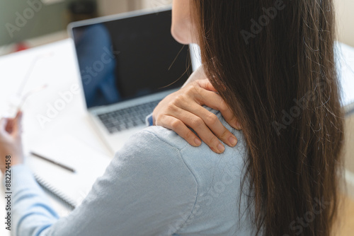 Office workers have neck pain from bad posture during sitting and work.